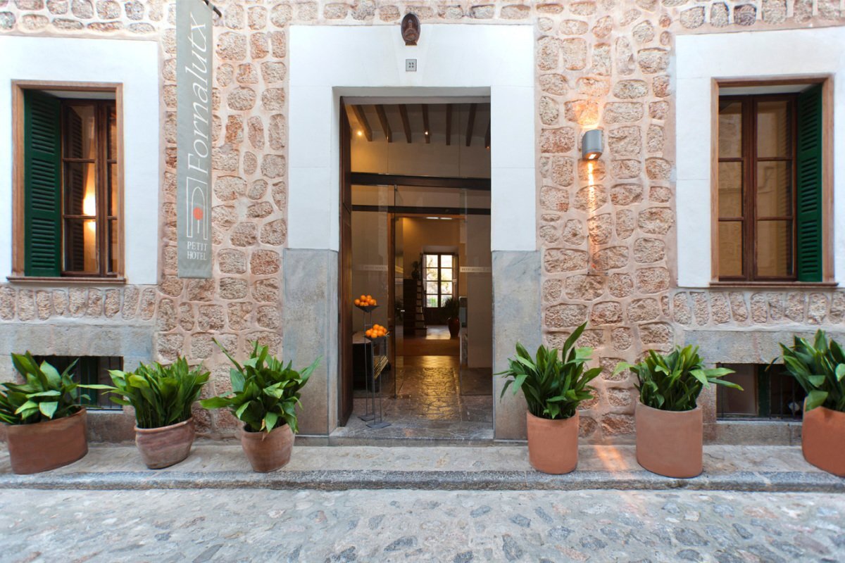 A stone building with a sign that says ' formalix ' on it