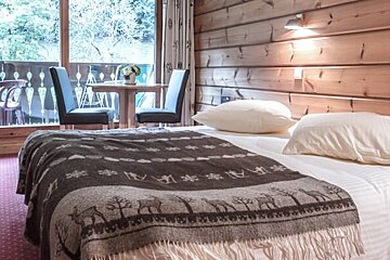 A bed with a blanket that says ' a ' on it