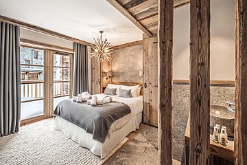 A bedroom with a large bed and a sink