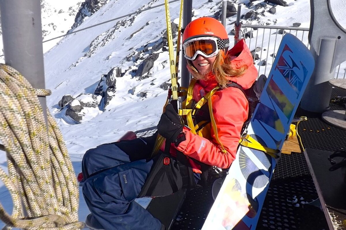 a snowboarder about to set off on a zip wire