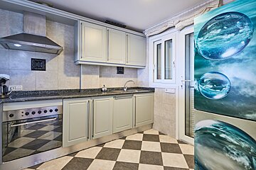 A kitchen with a picture of water bubbles on the refrigerator