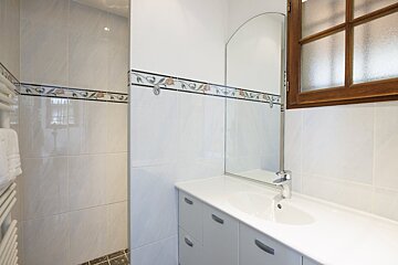 A bathroom with a sink a mirror and a window