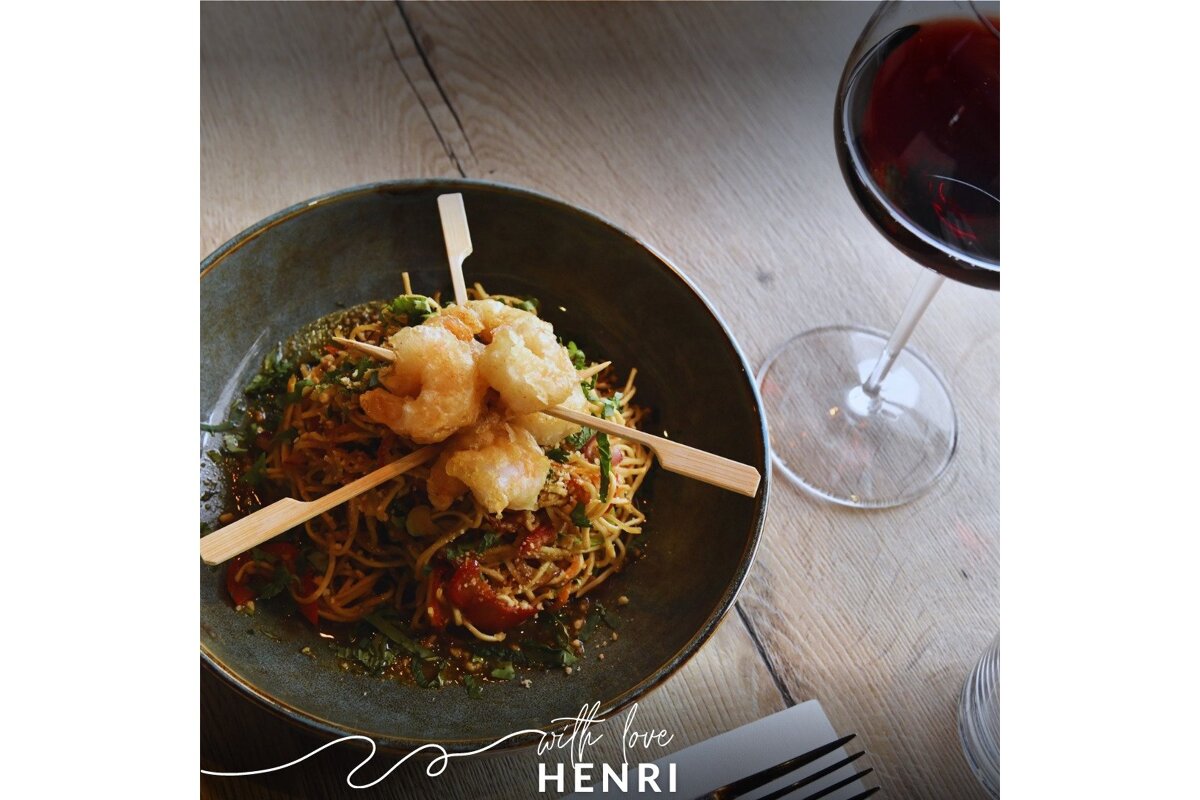 A bowl of food with a glass of wine and the words with love henri