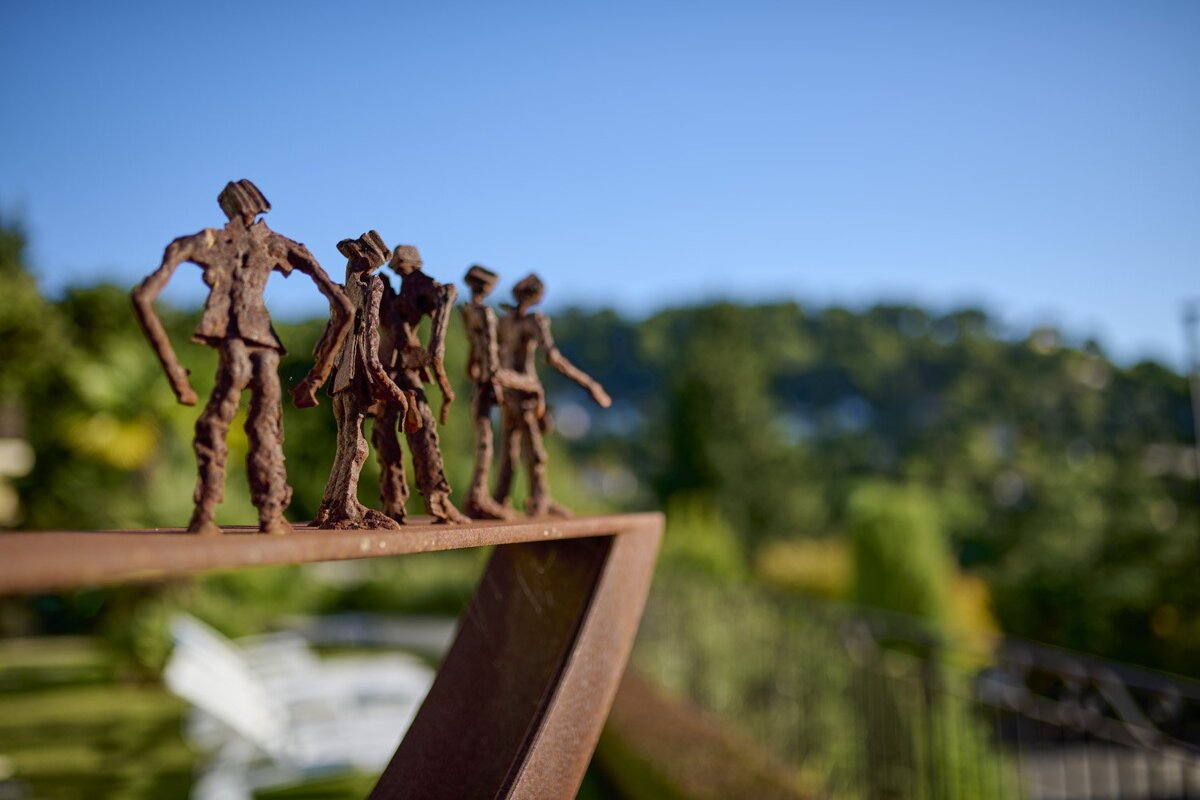 A sculpture of a group of people standing next to each other