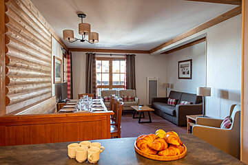 A bowl of croissants sits on a counter in a living room