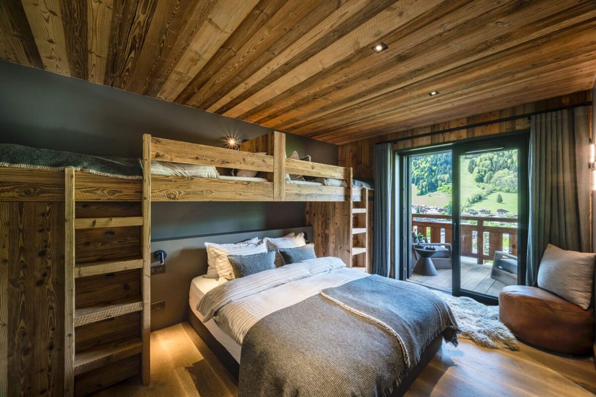 A bedroom with bunk beds and a sliding glass door