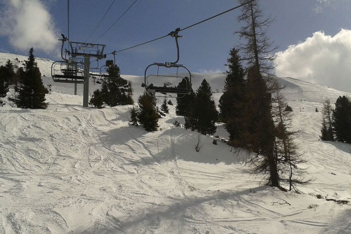 a chair lift going over some snow and trees