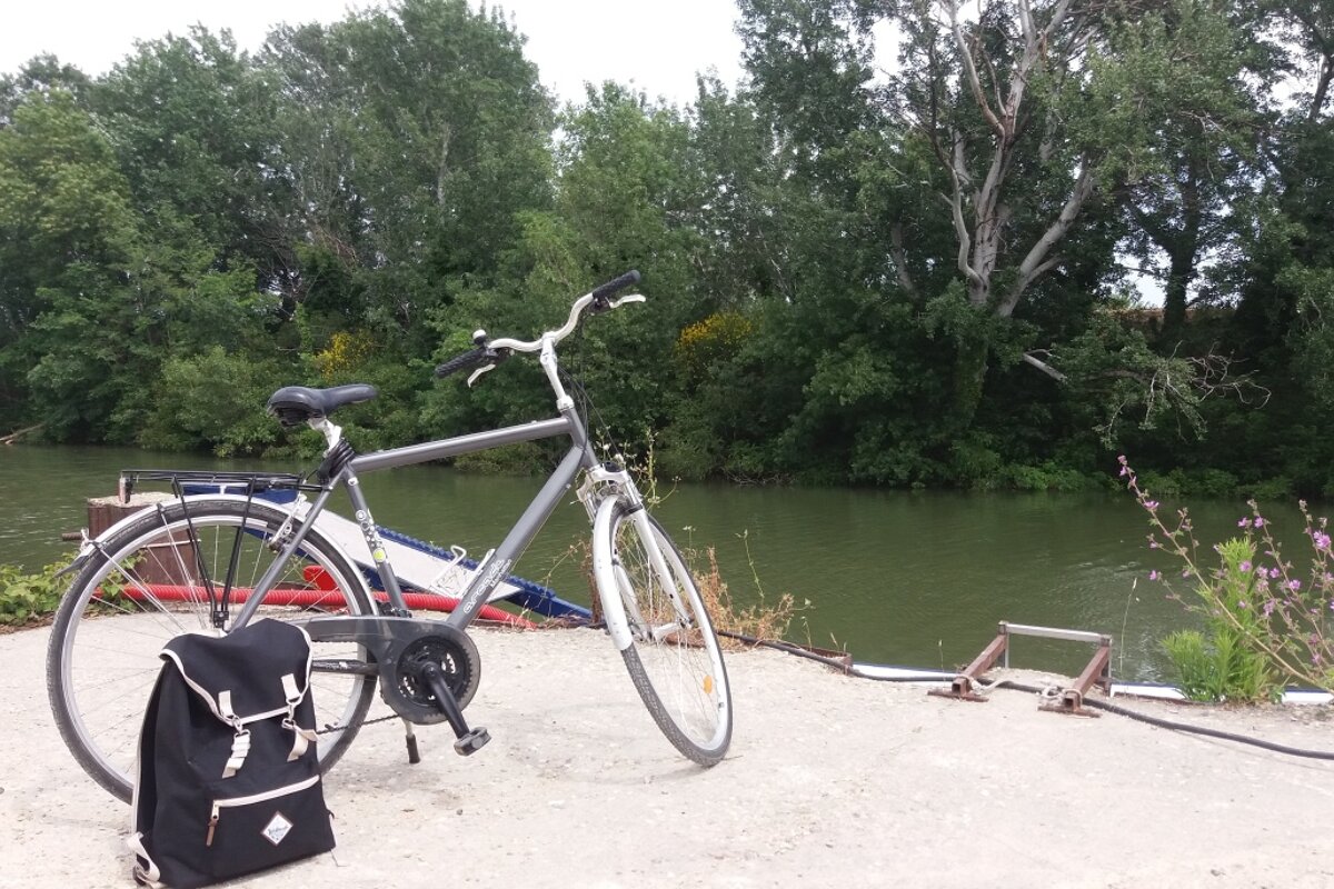 a bike resting against a river