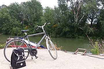 a bike resting against a river