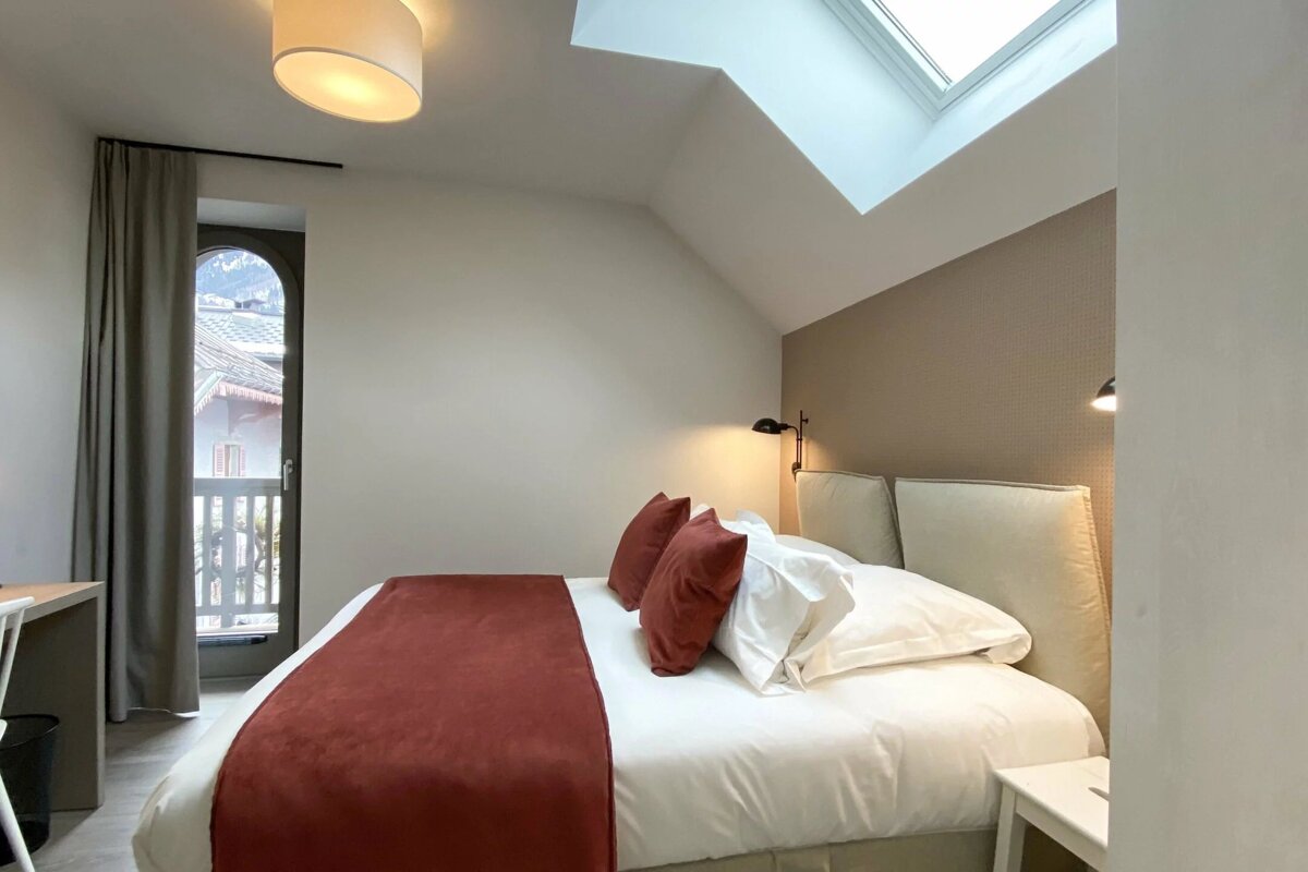 A bedroom with a large bed and a window