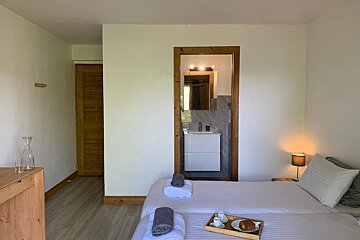 A bedroom with two beds and a tray of food on the bed