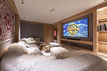 A room with a large screen that says ' warner bros ' on it