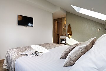 A bedroom with a large bed and a flat screen tv