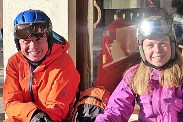 a man and woman in ski gear