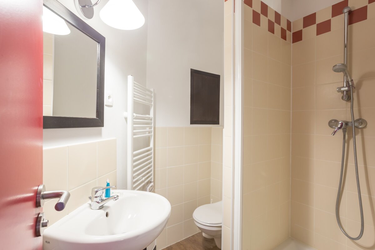 A bathroom with a sink a toilet and a shower