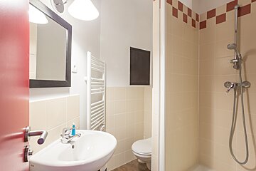 A bathroom with a sink a toilet and a shower