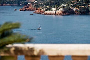 A boat is floating on the water near a small island