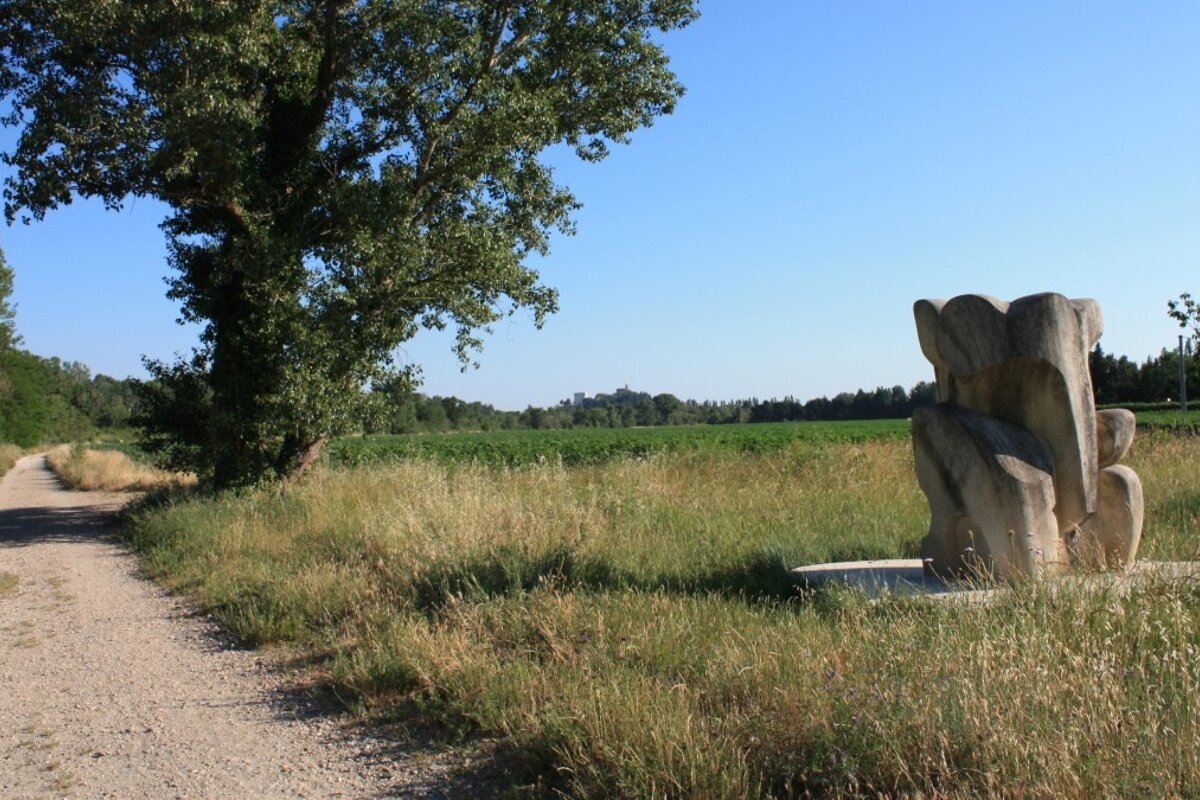 a sculpture on a walking path in provence