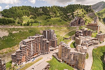 An aerial view of a ski resort with mountains in the background