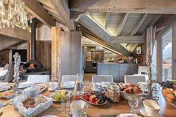 A dining room table with a variety of food on it