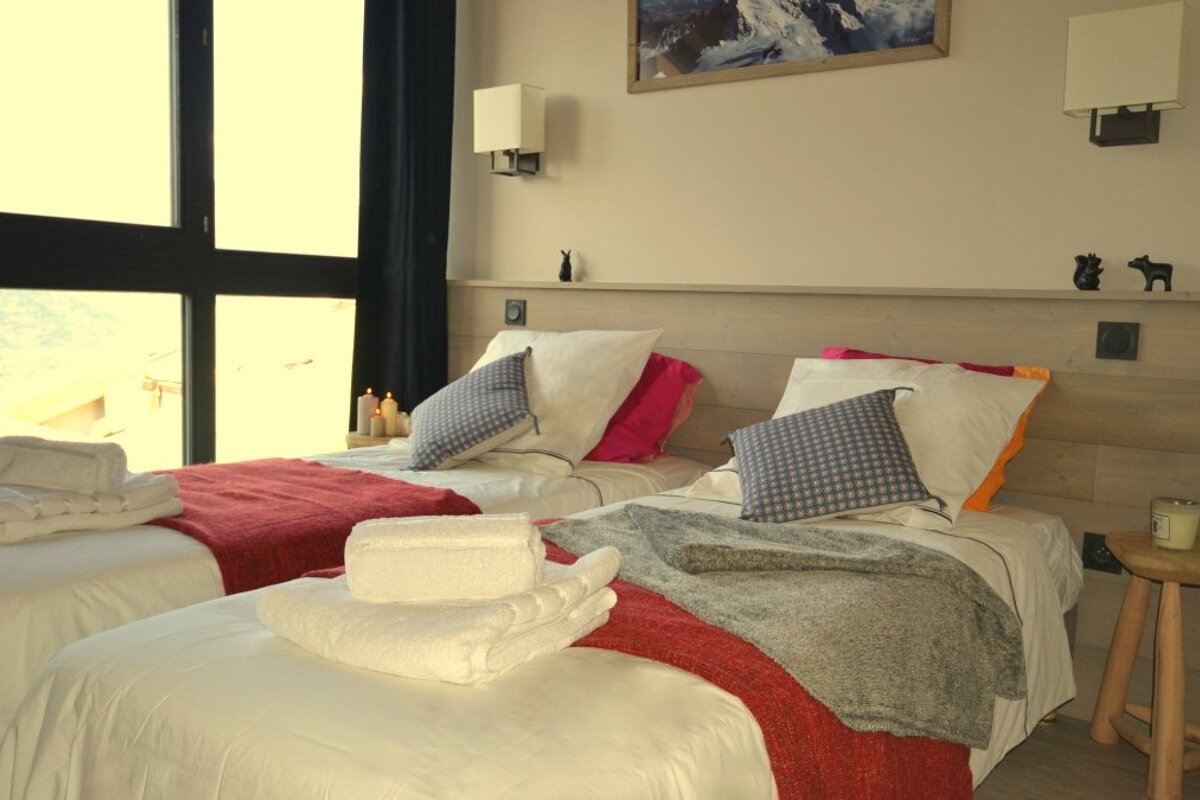 a twin bedroom in a chalet in la plagne