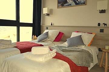 a twin bedroom in a chalet in la plagne