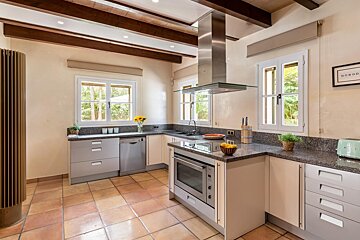 A kitchen with a sign on the wall that says good