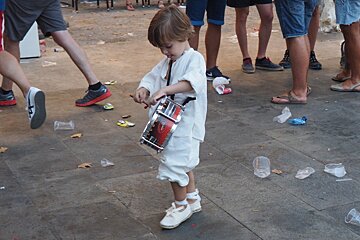 a young drummer joining in the festivities