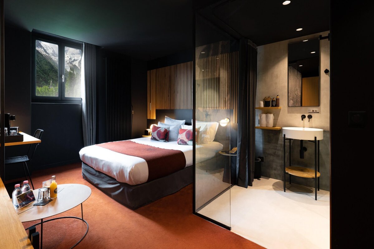 A hotel room with a bed and a sink