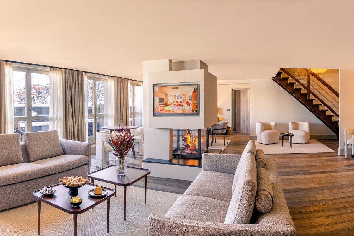 A living room with a fireplace and a flat screen tv