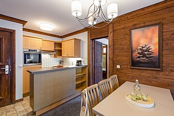 A kitchen with a picture of a pine cone on the wall