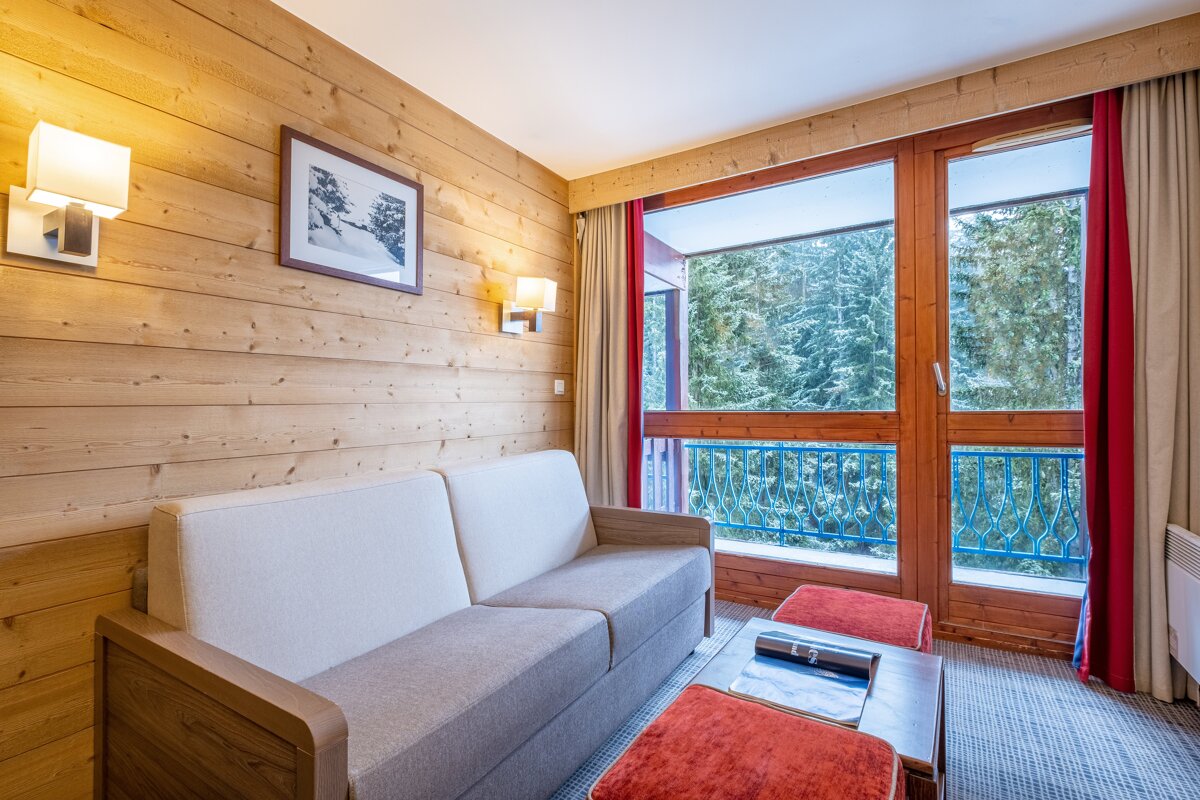 A living room with a couch and a picture on the wall