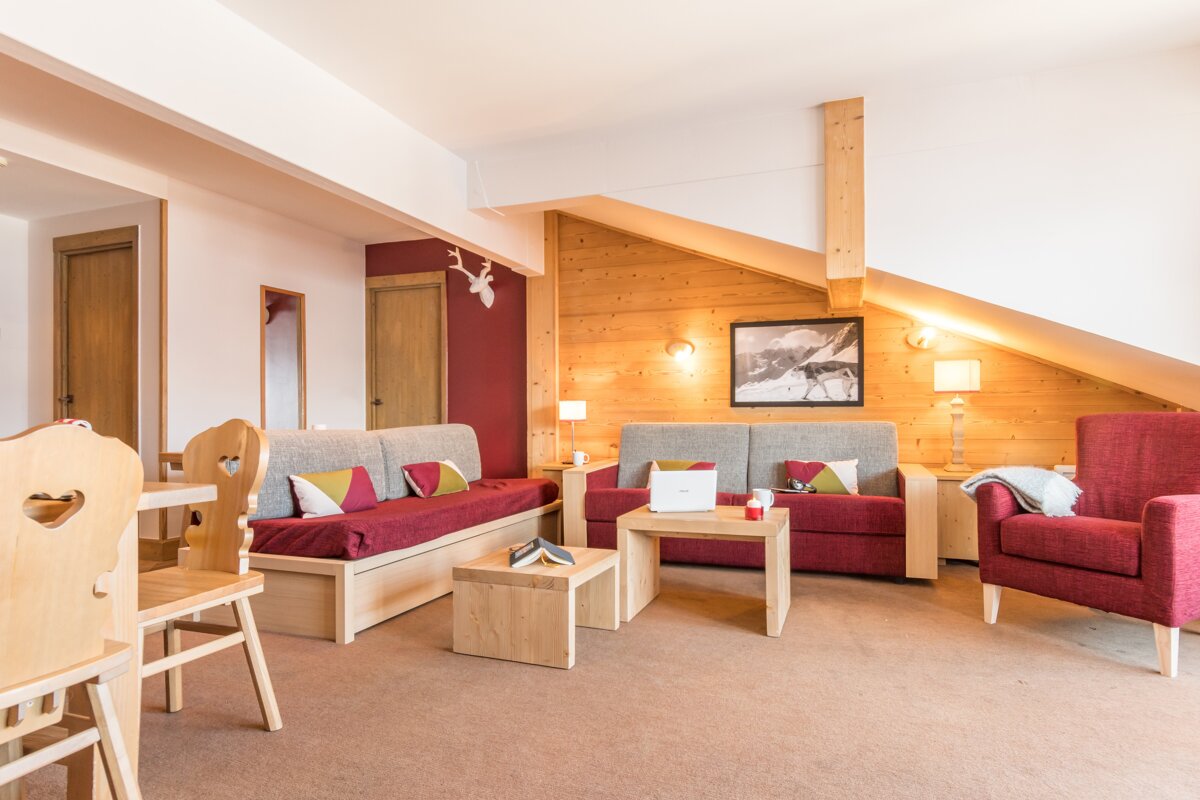 A living room with a couch a chair and a table