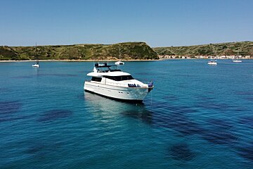 A large white boat is floating in a body of water