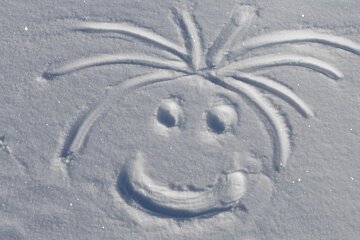 a face drawn in the snow