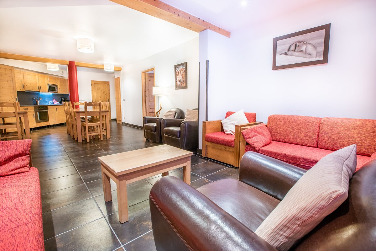 A living room with a couch a chair and a table