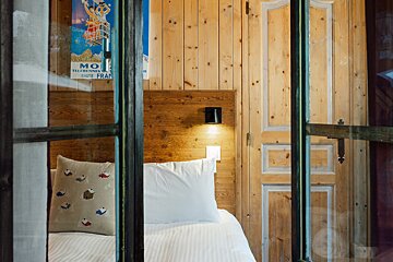 A room with a bed and a poster that says hotel