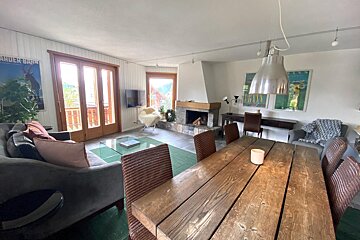 A living room with a fireplace and a poster that says ruder bank