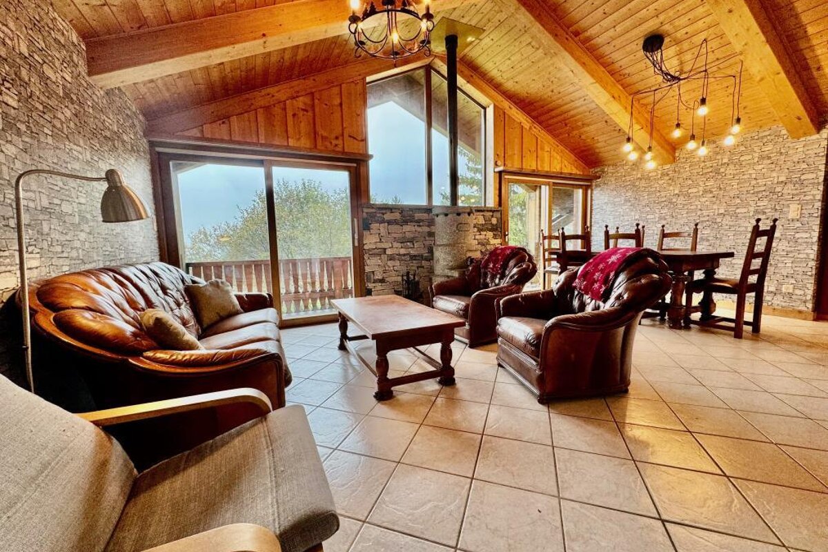 A living room with a couch and chairs and a table