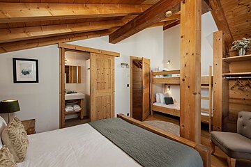 A bedroom with a king size bed and bunk beds