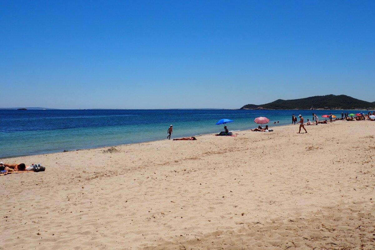 a long white stretch of sand in ibiza