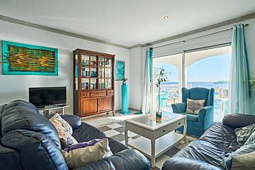 A living room with a blue couch and a blue chair