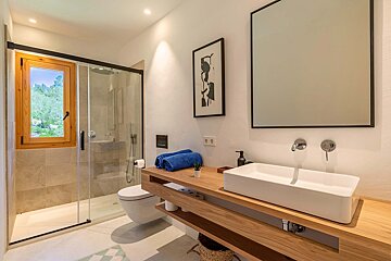 A bathroom with a toilet a sink and a mirror