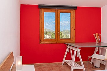 A room with red walls and a wooden window