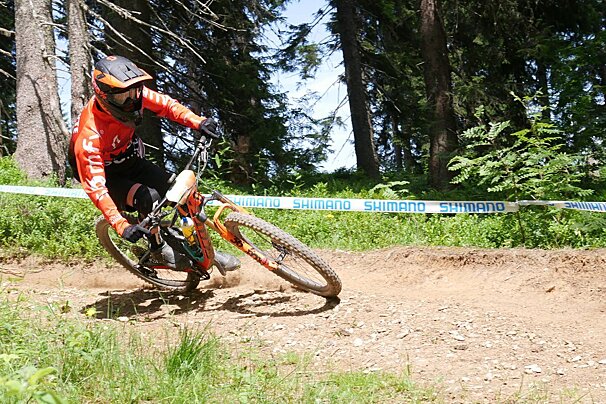 A person riding a bike with a shimano tape behind them