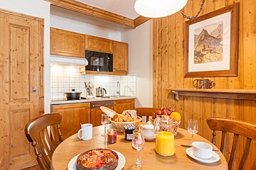 A kitchen with a picture of a horse on the wall