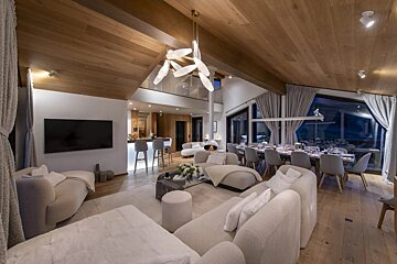 A living room with white furniture and a flat screen tv