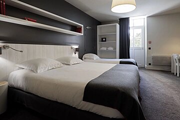 A hotel room with two beds and a fire extinguisher