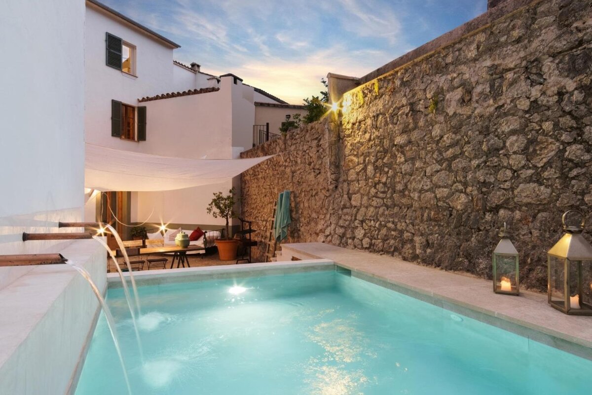 A swimming pool with a stone wall in the background