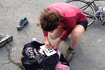 a woman pinning a race number on her jersey